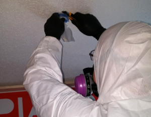 technician collecting an asbestos sample